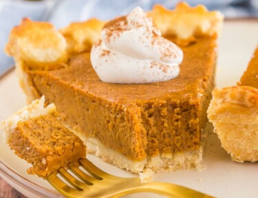 a slice of pumpkin pie with a bite taken out of it