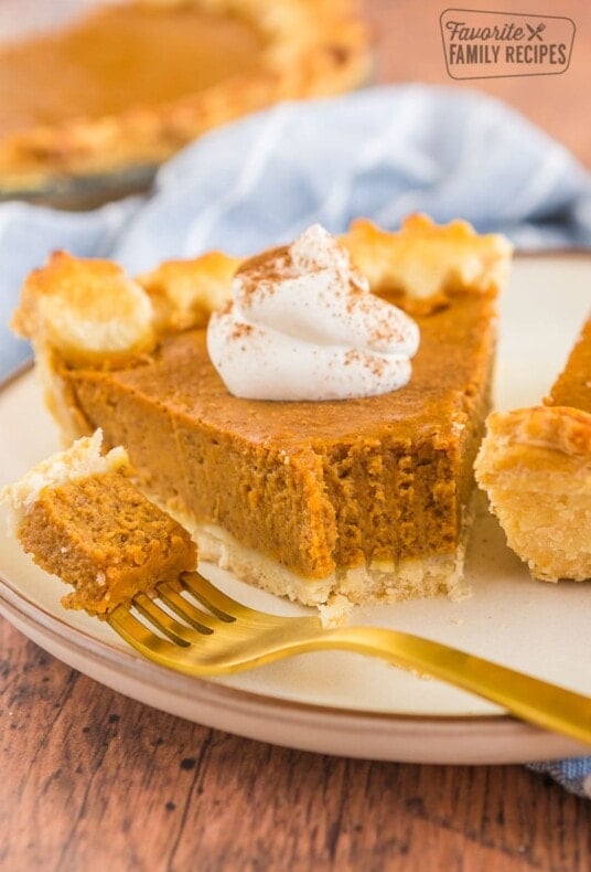 a slice of pumpkin pie with a bite taken out of it