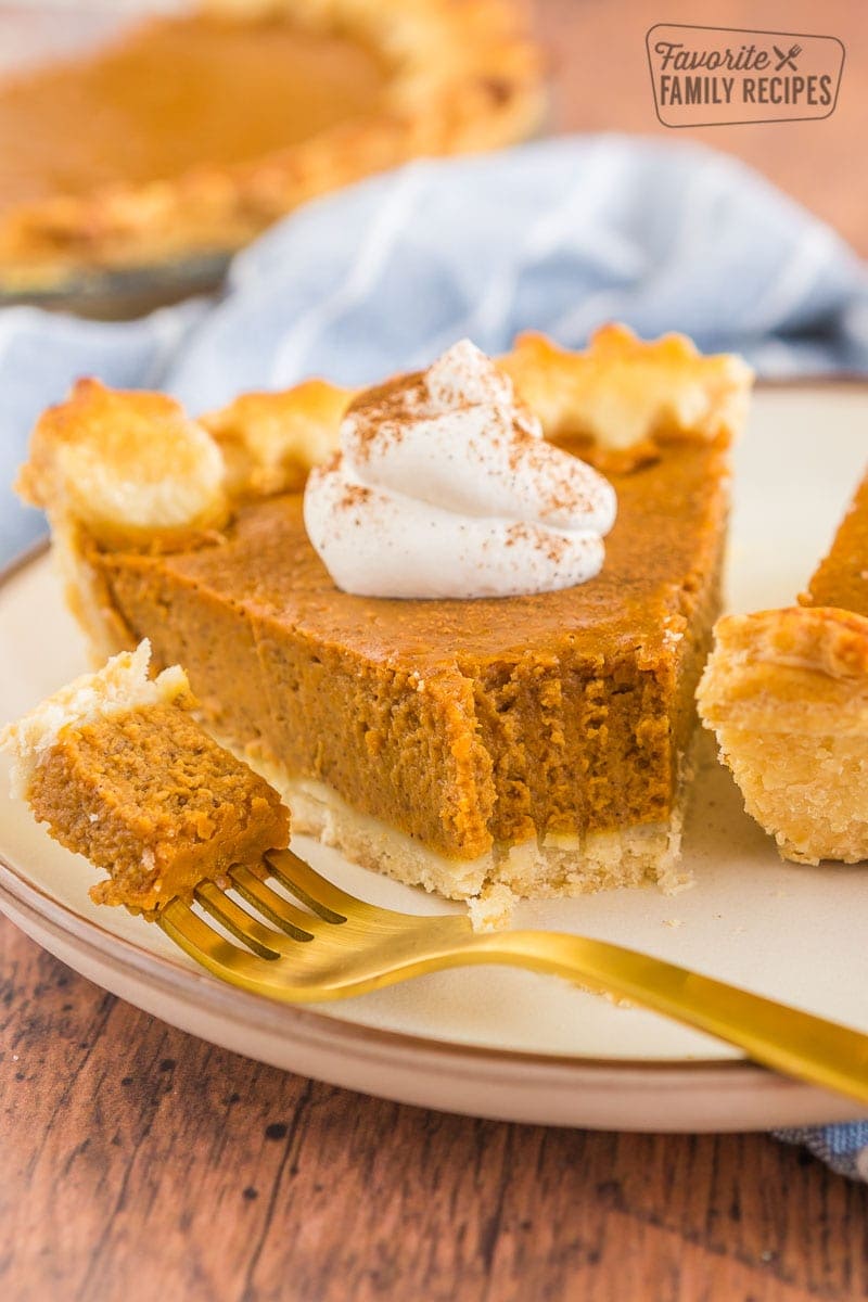 a slice of pumpkin pie with a bite taken out of it