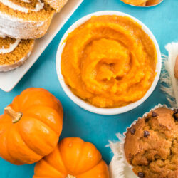 A bowl of pumpkin puree next to some baked pumpkin items