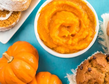 A bowl of pumpkin puree next to some baked pumpkin items