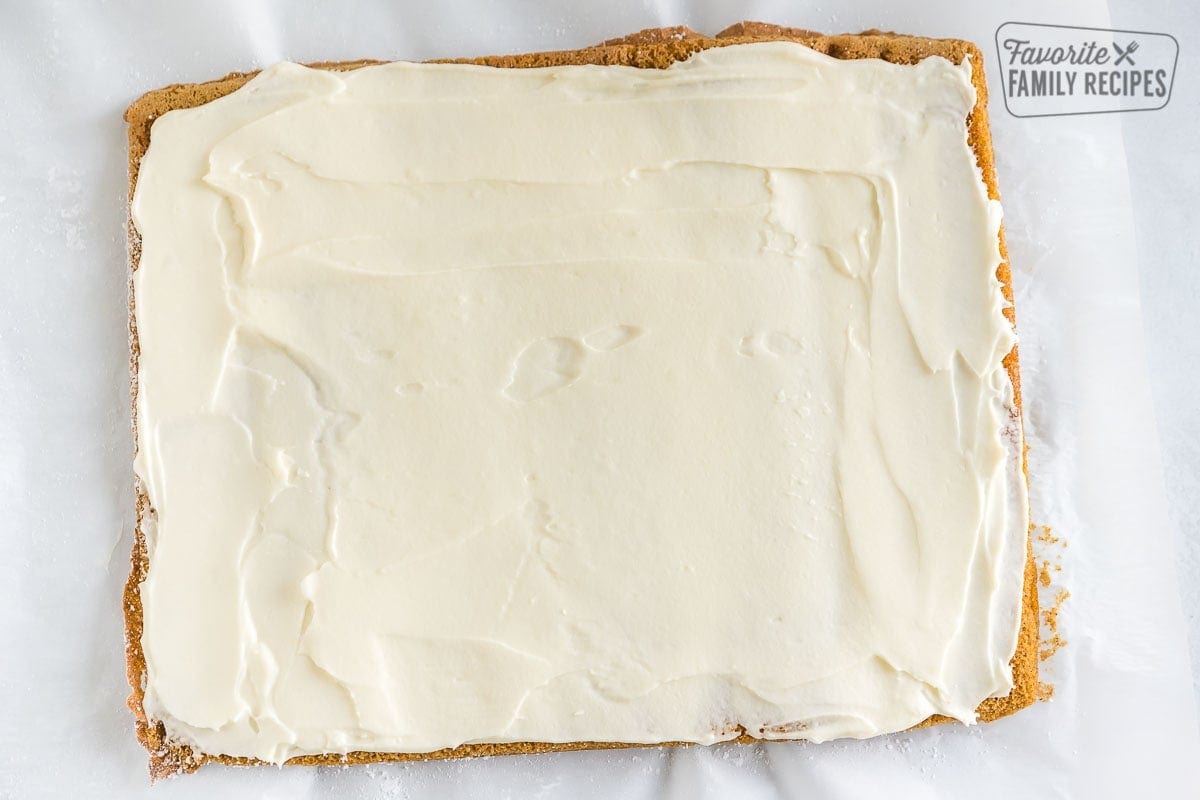Cream cheese filling spread over a cake