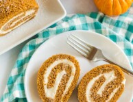 Two slices of pumpkin roll on a plate