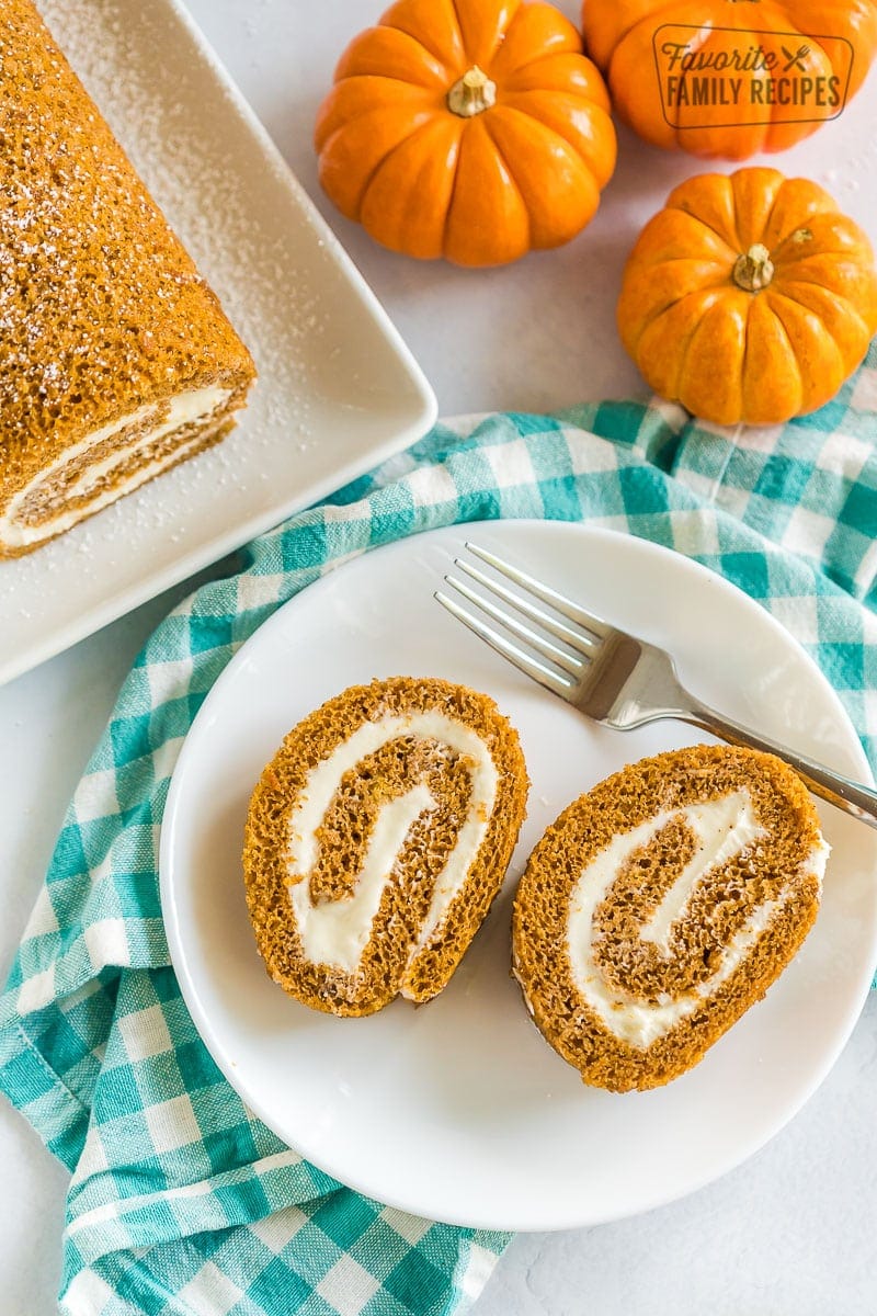 Two slices of pumpkin roll on a plate