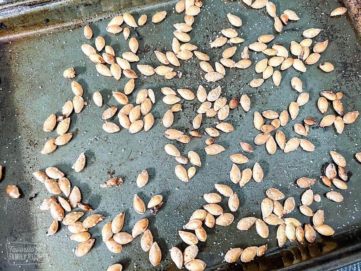 Roasted pumpkin seeds on a baking sheet