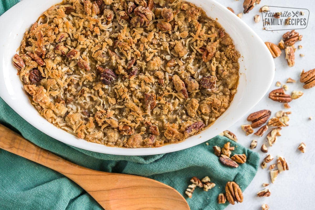 Baked Sweet Potato Casserole with wooded spoon next to it