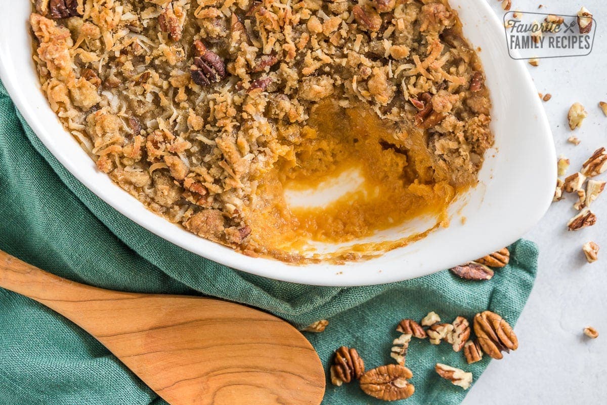 Sweet potato casserole with a scoop of it removed from the casserole dish. 