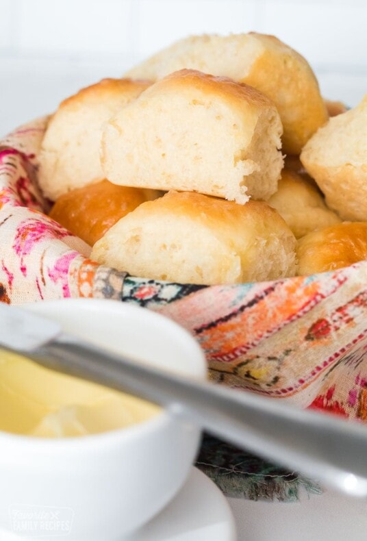 Dinner rolls stacked in a basket
