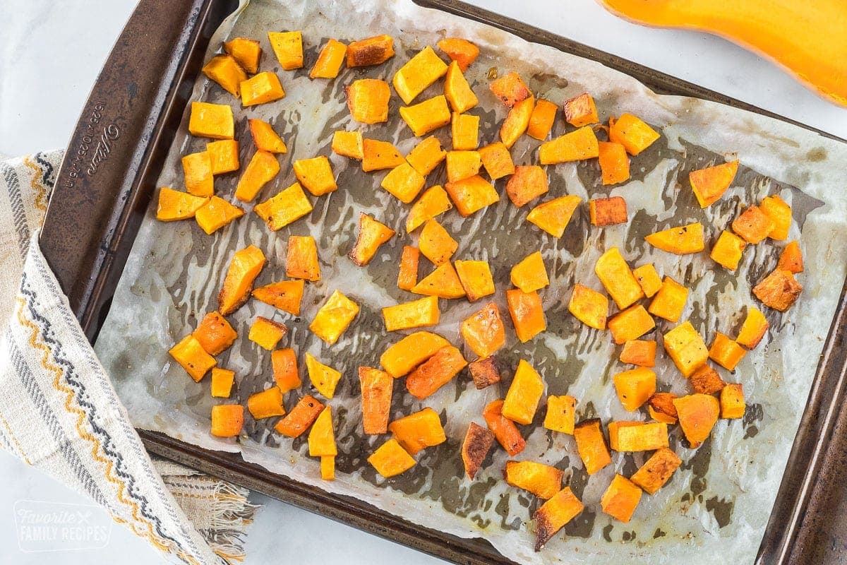 Roasted butternut squash in cubes on a baking sheet