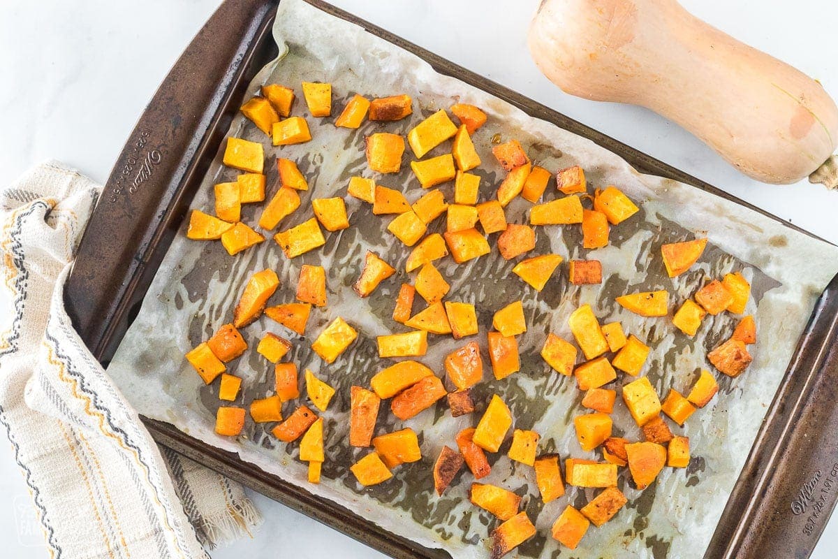 Butternut squash on a baking sheet.