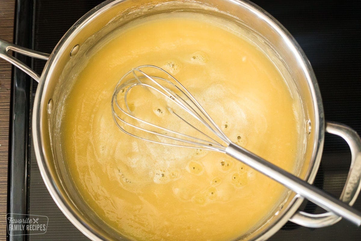 roux made with flour and butter on a stovetop being stirred with a whisk