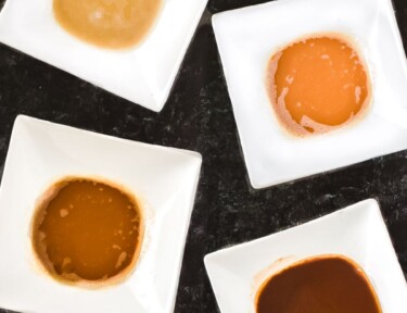 The 4 types of roux including white, blond, brown, and dark in white bowls