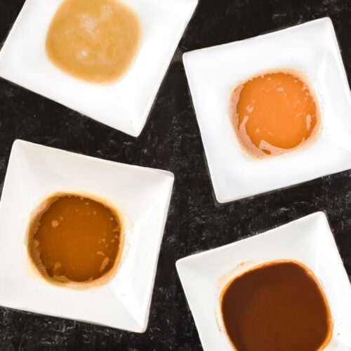 The 4 types of roux including white, blond, brown, and dark in white bowls