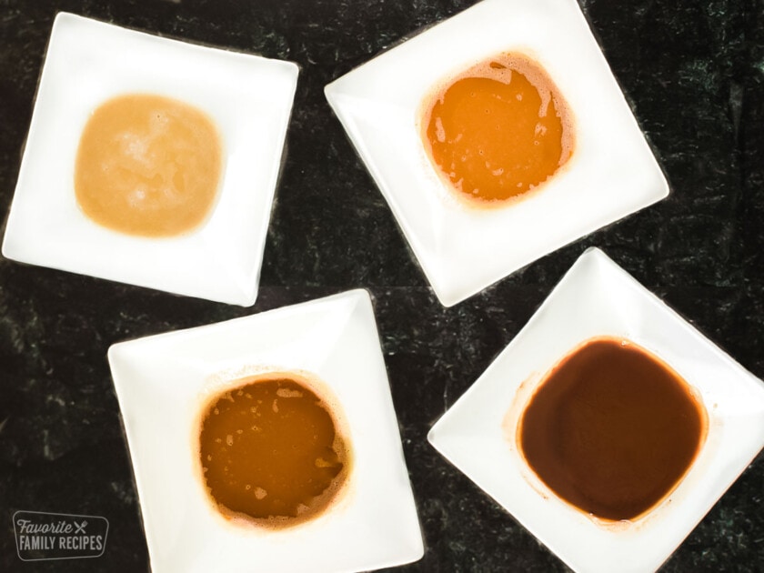 The 4 types of roux including white, blond, brown, and dark in white bowls