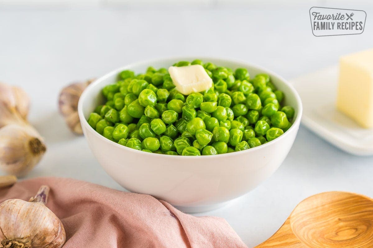 Green peas in a bowl topped with butter