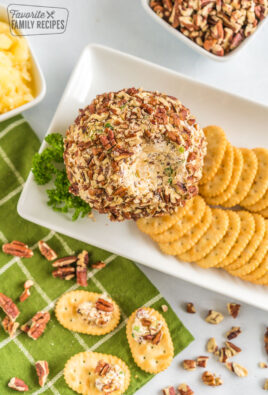 Pineapple cheese ball on a platter with crackers
