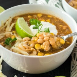 A close up of a bowl of chili made with chicken and white beans