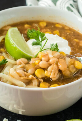 A close up of a bowl of chili made with chicken and white beans