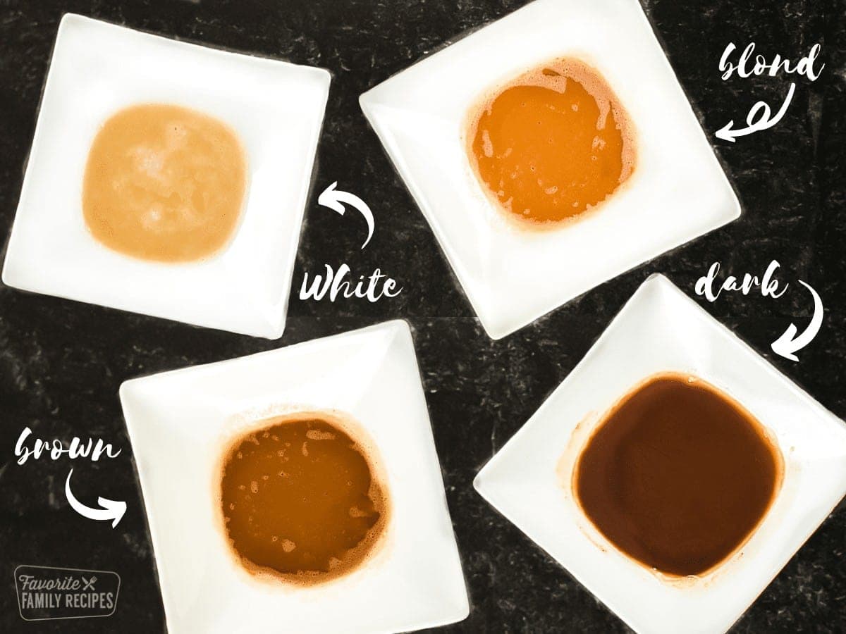 The 4 types of roux including white, blond, brown, and dark in white bowls