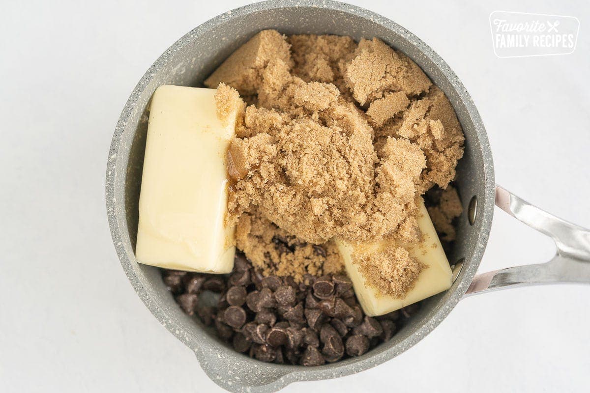 Brown sugar, butter, and chocolate chips in a saucepan.
