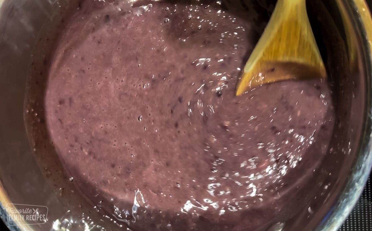 Black beans being stirred in a pot