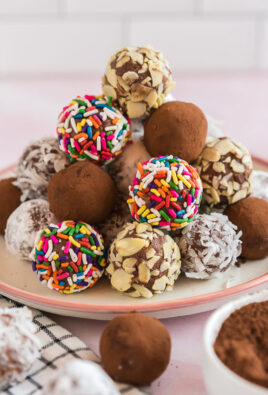 A stack of chocolate truffles on a plate