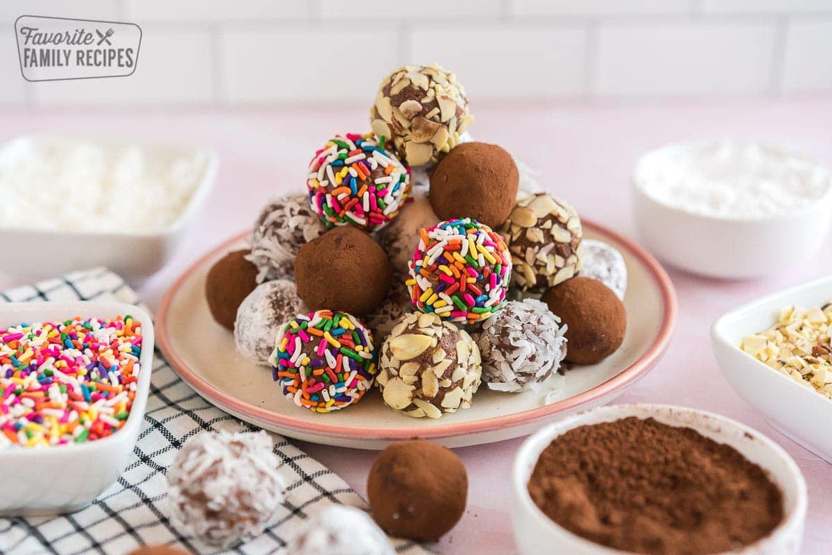 A stack of chocolate truffles on a plate.