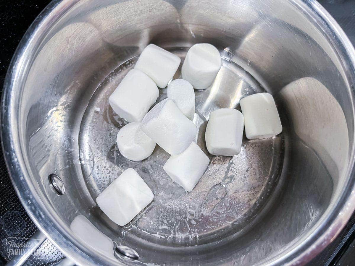 marshmallows and light corn syrup in a pan to make almond joys