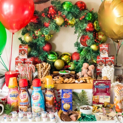 Creamers, treats, whipped cream, and other toppings to make a hot chocolate bar.