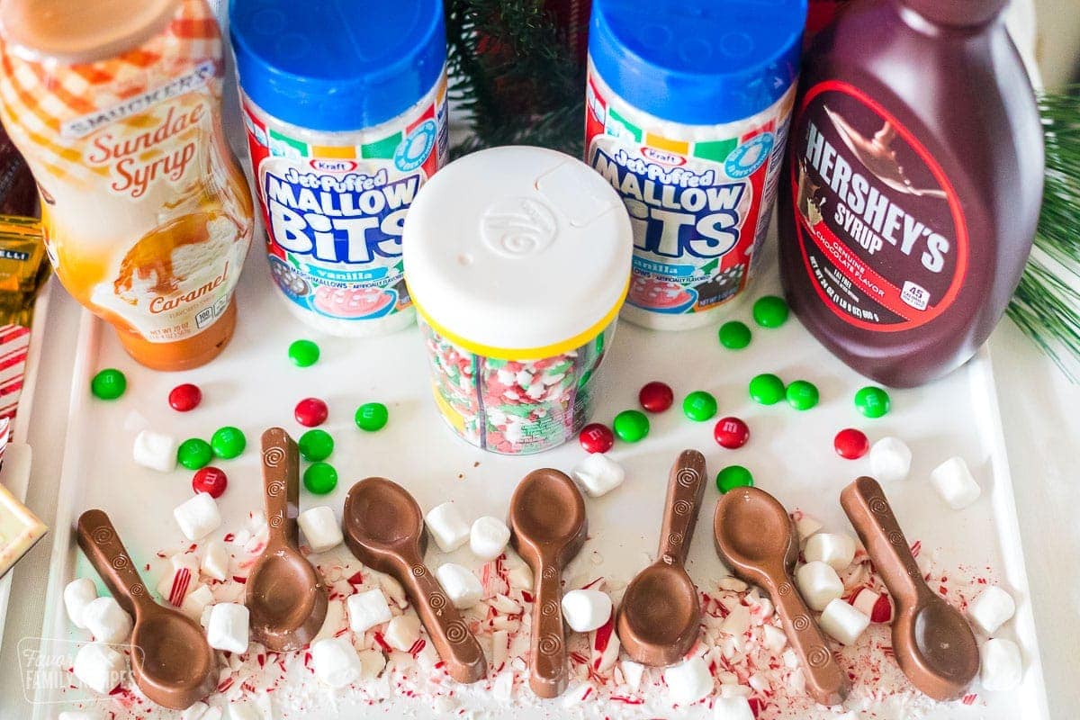 Chocolate stirring spoons and hot chocolate toppings on a tray