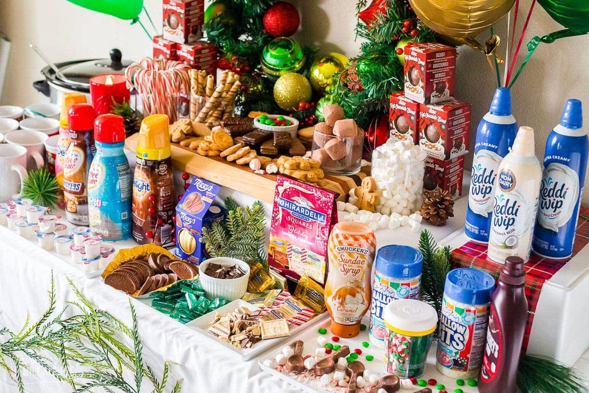 A table full of ingredients to add to hot chocolate for a party