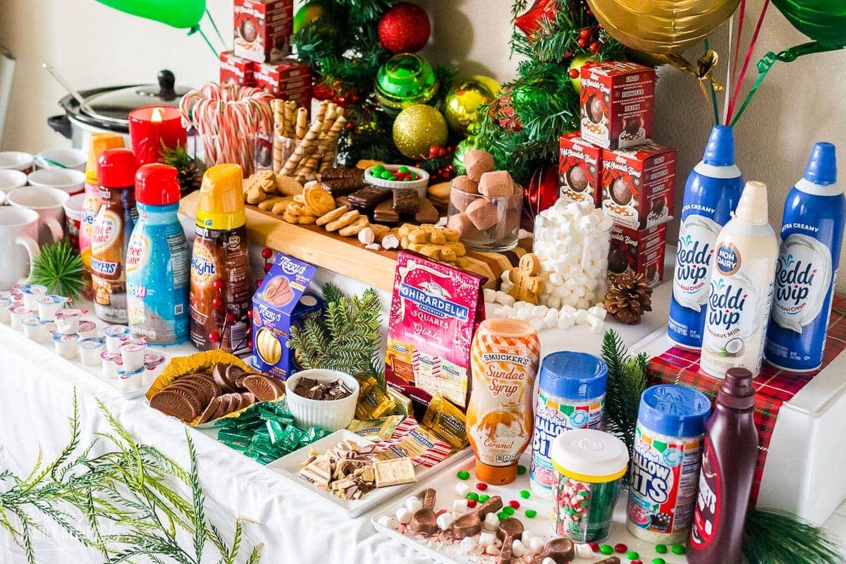 A table full of ingredients to add to hot chocolate for a party.