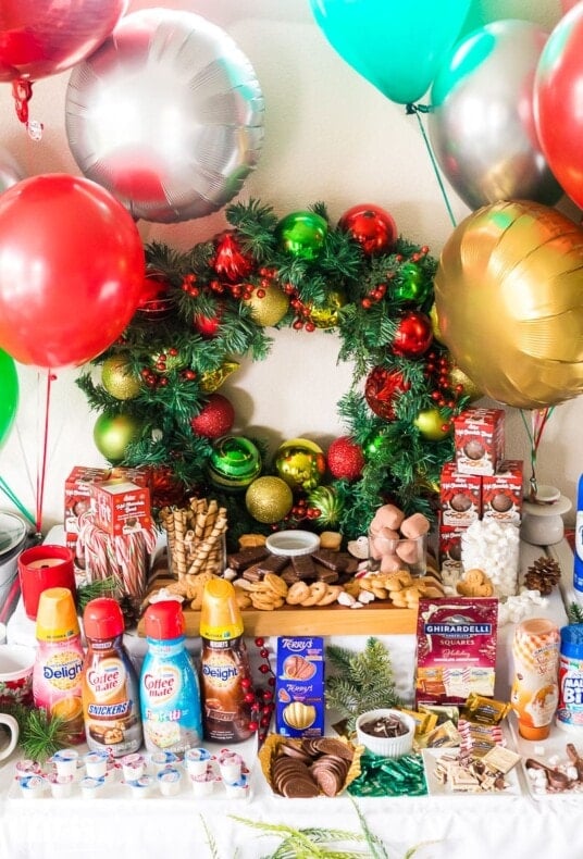 Creamers, treats, whipped cream, and other toppings to make a hot chocolate bar.