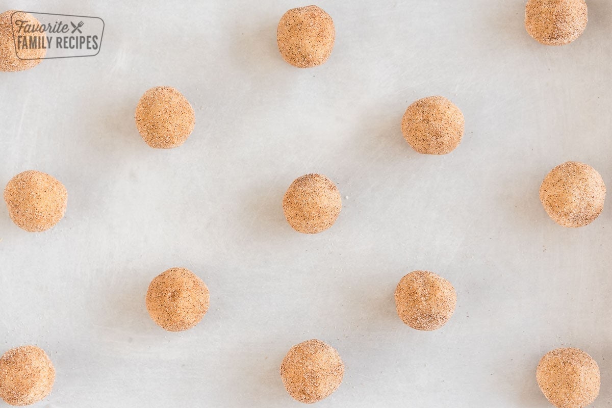 Snickerdoodle cookie dough balls on a baking sheet before baking