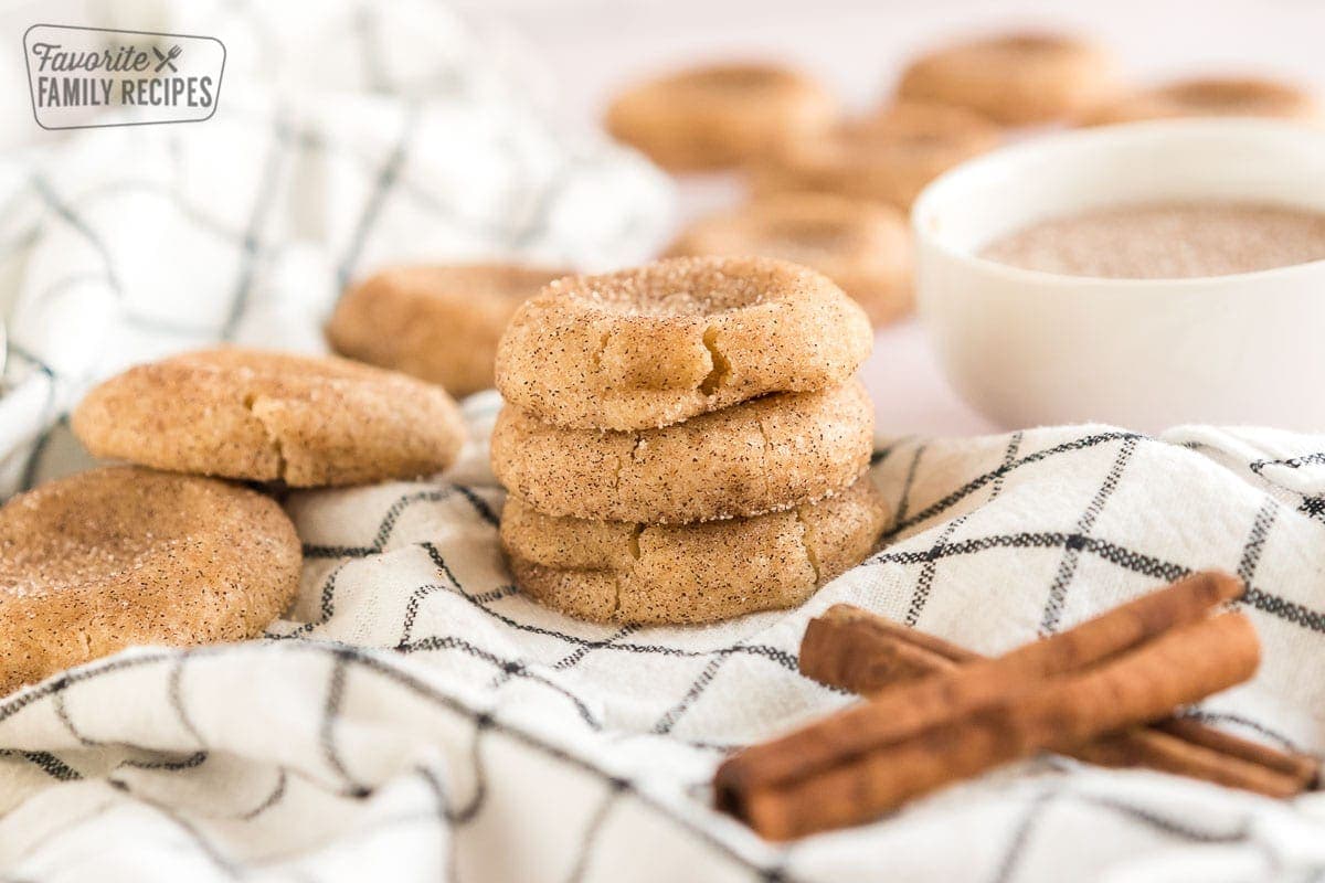 These cinnamon sugar cookies recipe transforms a classic sugar cookie into a tasty Fall treat. Cinnamon sugar cookies are a classic cookie that’s known for its cinnamon and sugar coating. A stack of snickerdoodles on a dishcloth.