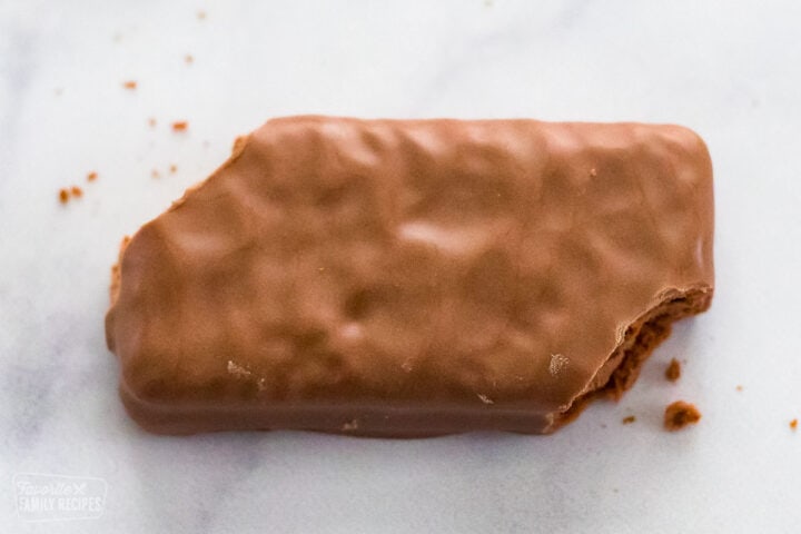 A very close up view of a Tim Tam with two opposite corners bitten off