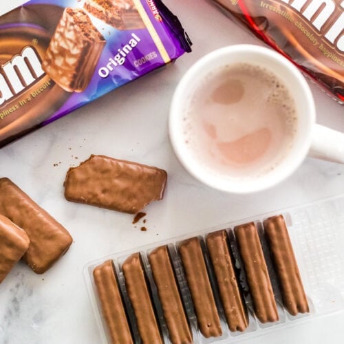 Packages of Tim Tams and a mug of hot chocolate