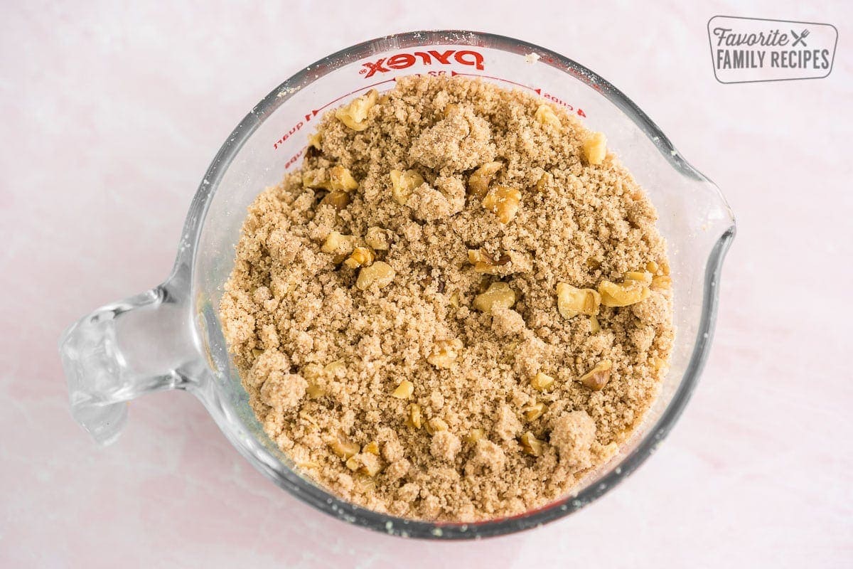 Streusel topping with walnuts in a measuring cup
