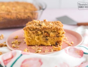 A piece of coffee cake on a pink plate