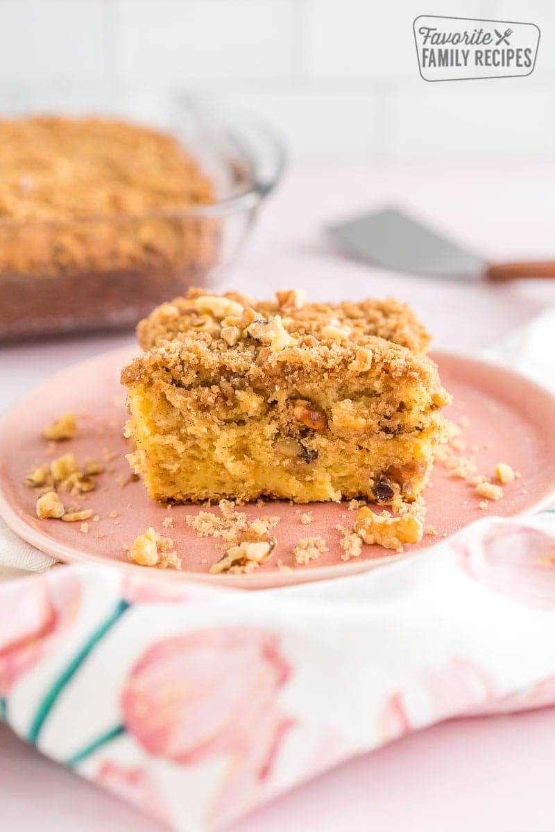 A piece of coffee cake on a pink plate