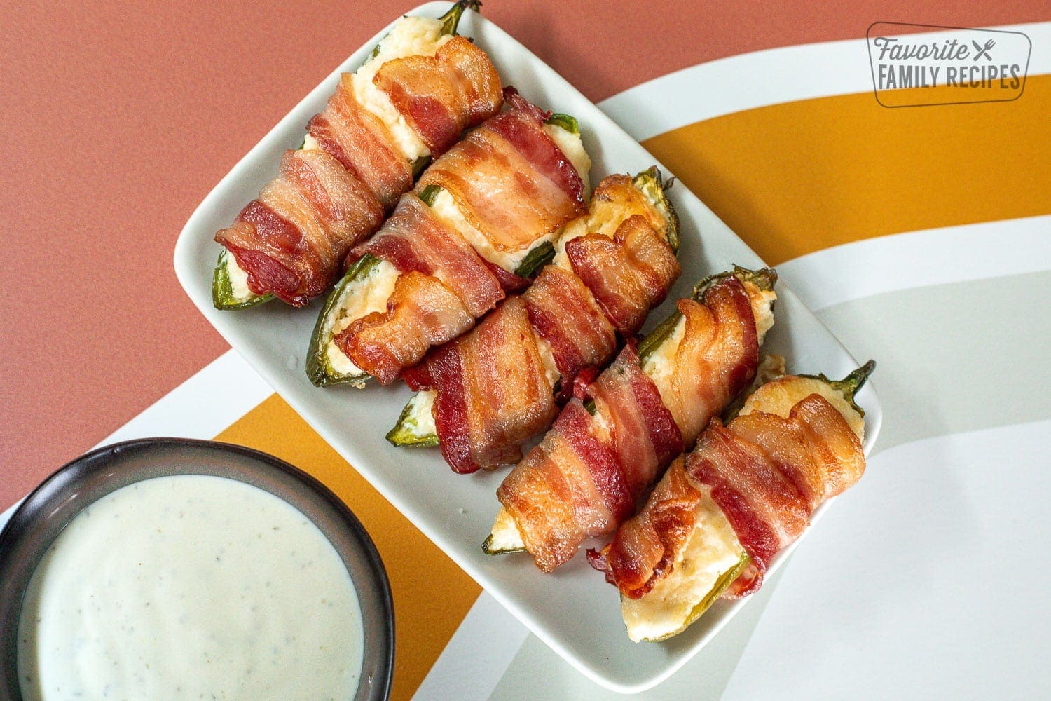 Bacon Wrapped Jalapeños poppers on a plate for serving.