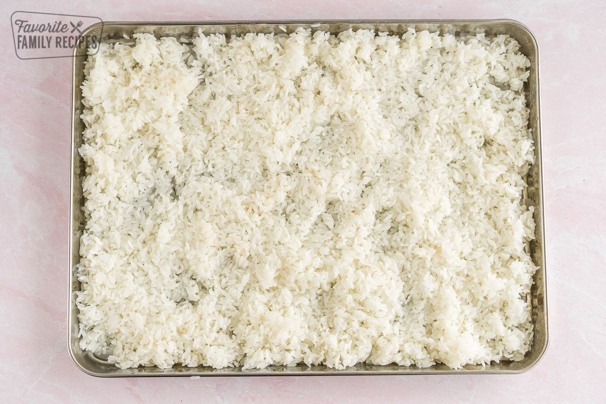 Rice spread out on a baking sheet