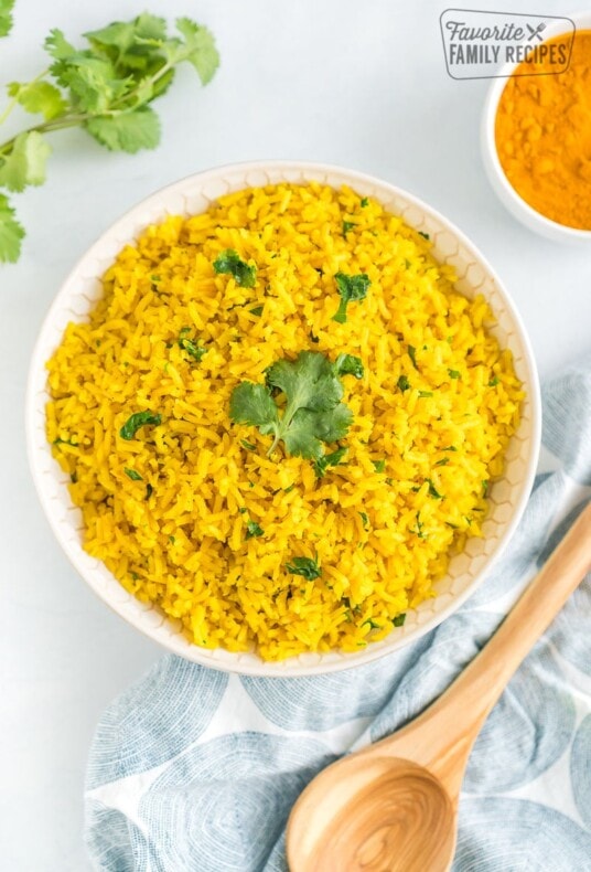 Yellow rice in a bowl topped with cilantro