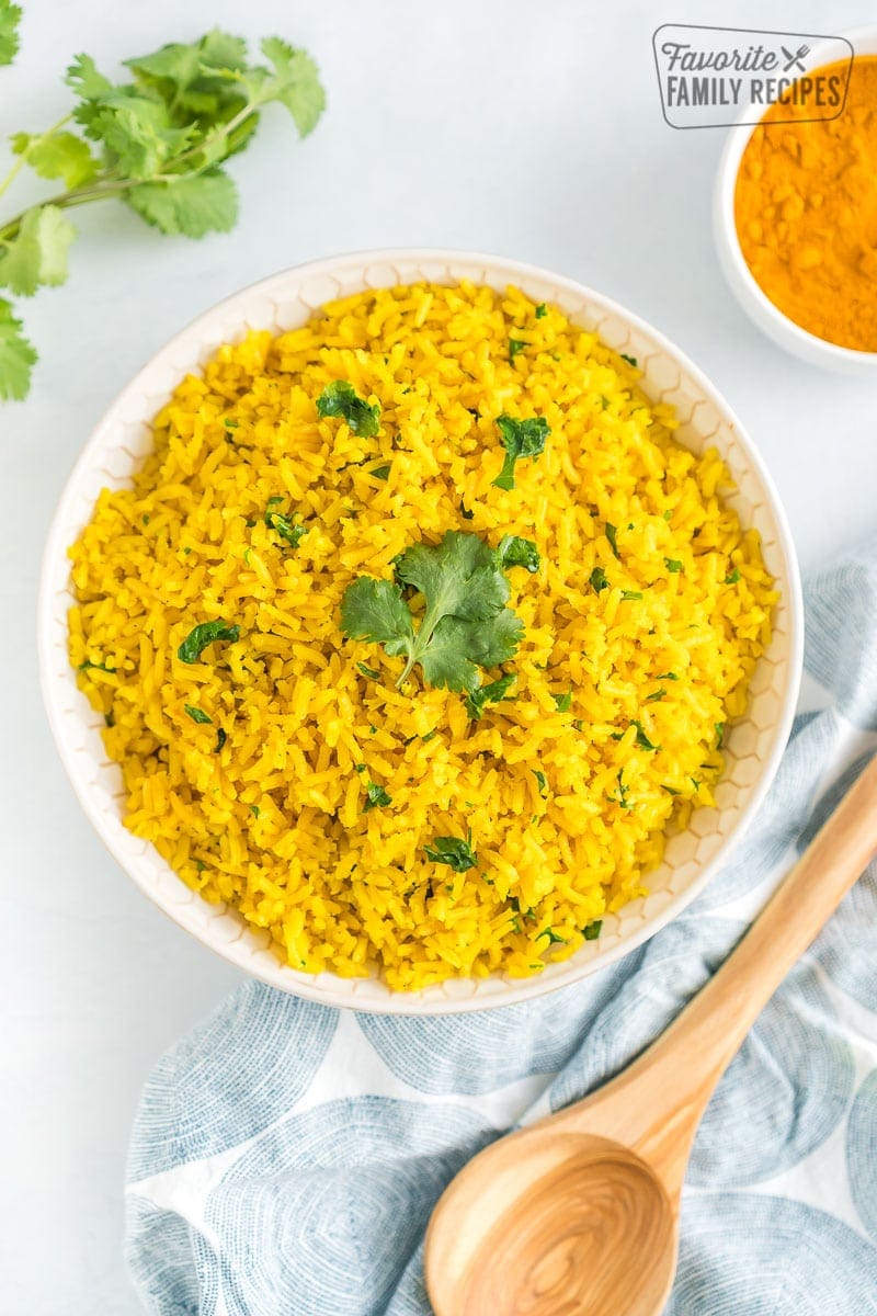 Yellow rice in a bowl topped with cilantro