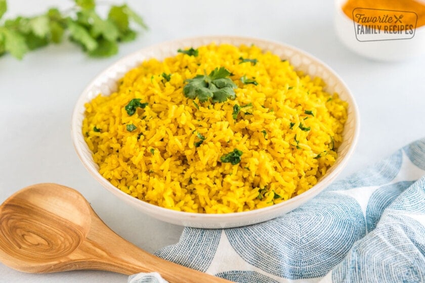 Yellow rice in a bowl topped with cilantro