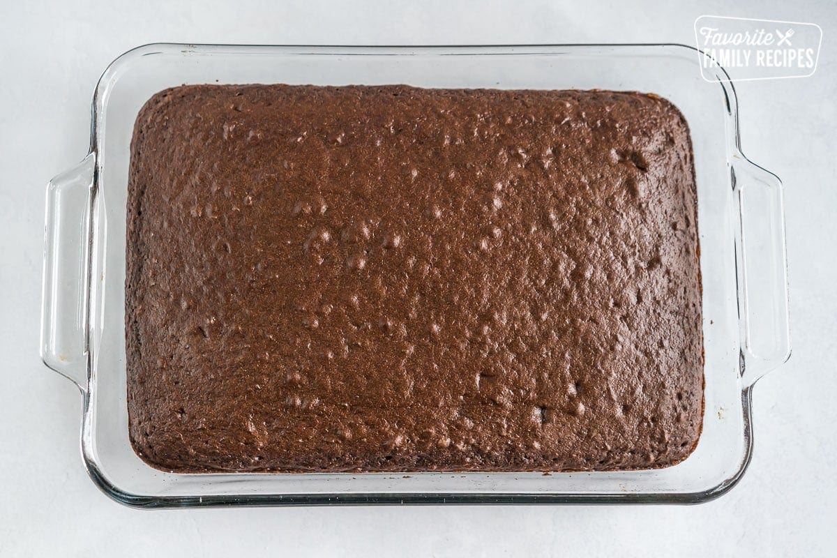 A chocolate cake in a glass baking dish for Better Than Sex Cake.