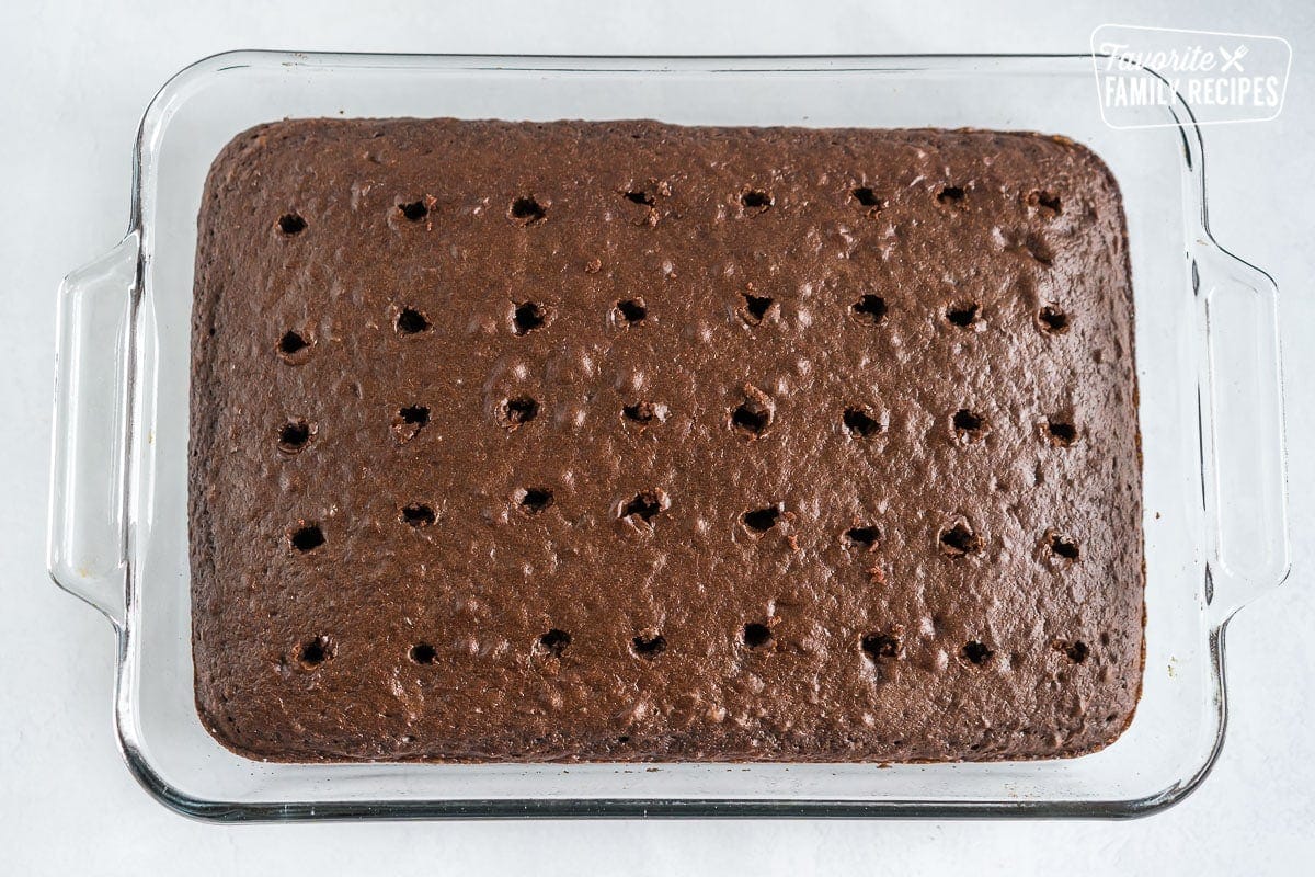 A chocolate cake with holes poked in the top