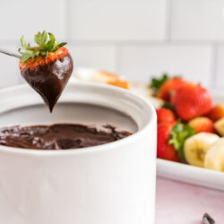 A strawberry dipped in chocolate fondue