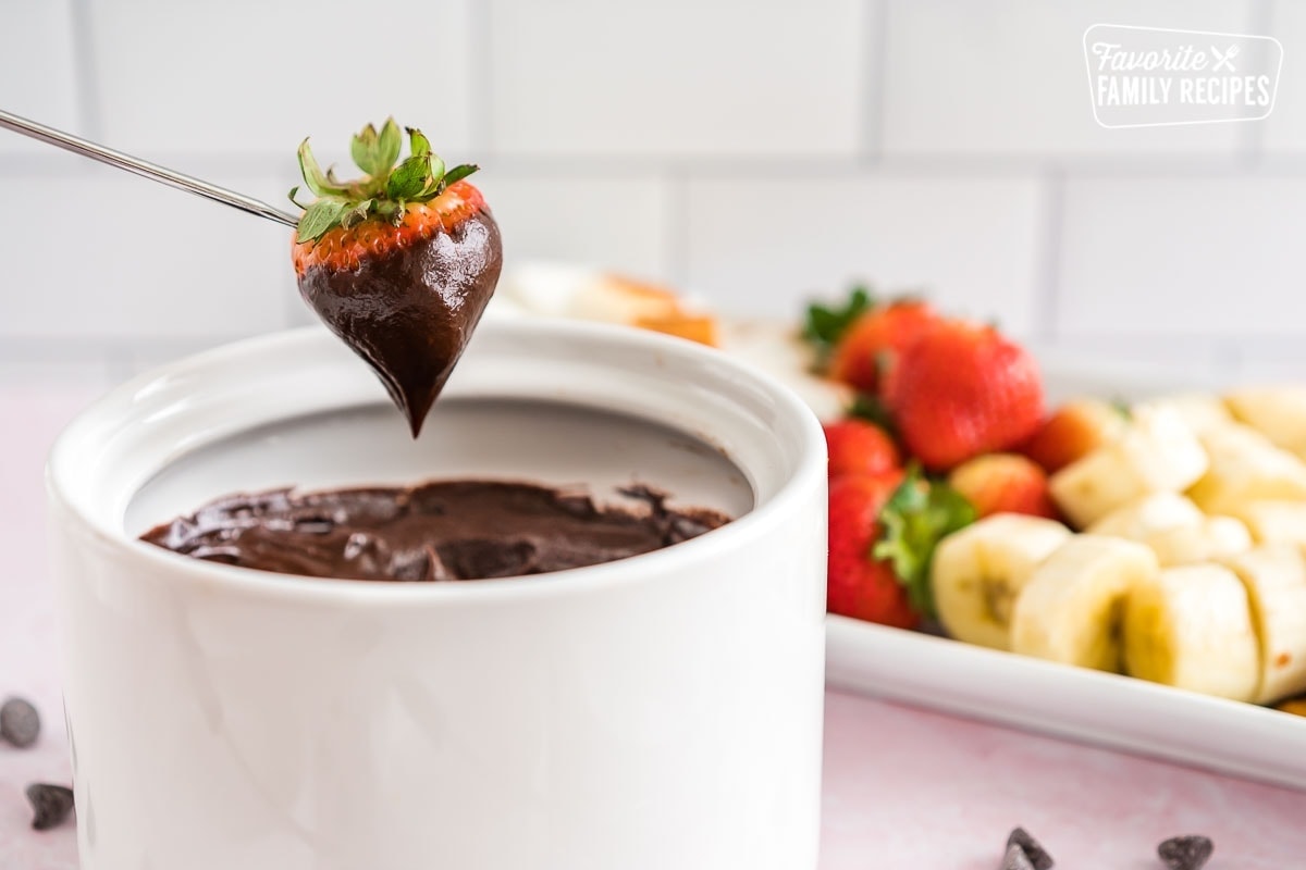 A strawberry dipped in chocolate fondue