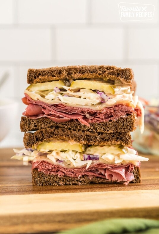 A corned beef sandwich cut in half and stacked one half on top of the other